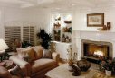 This warm, cozy family room is a product of balancing the large expanse of creamy white pigmented lacquer with the natural warmth of the raw silk sofas, limestone table and unvarnished woods of floor and table. Accessories were gathered from many countries to give the room a quietly intellectual ambiance. (Click to enlarge)